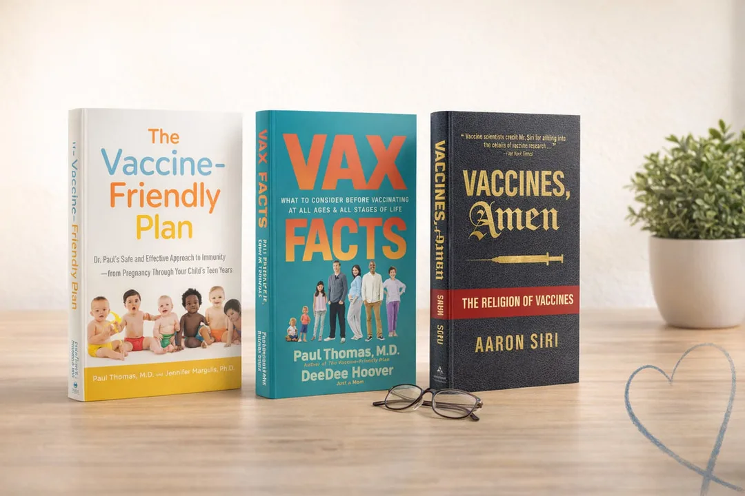 Three books on vaccine research standing upright on a warm wood surface -- The Vaccine-Friendly Plan by Paul Thomas, M.D. and Jennifer Margulis, Ph.D., Vax Facts by Paul Thomas, M.D. and DeeDee Hoover, and Vaccines, Amen by Aaron Siri -- with a pair of reading glasses in the foreground, a small potted plant to the right, and a soft brushstroke heart accent in the lower right corner.